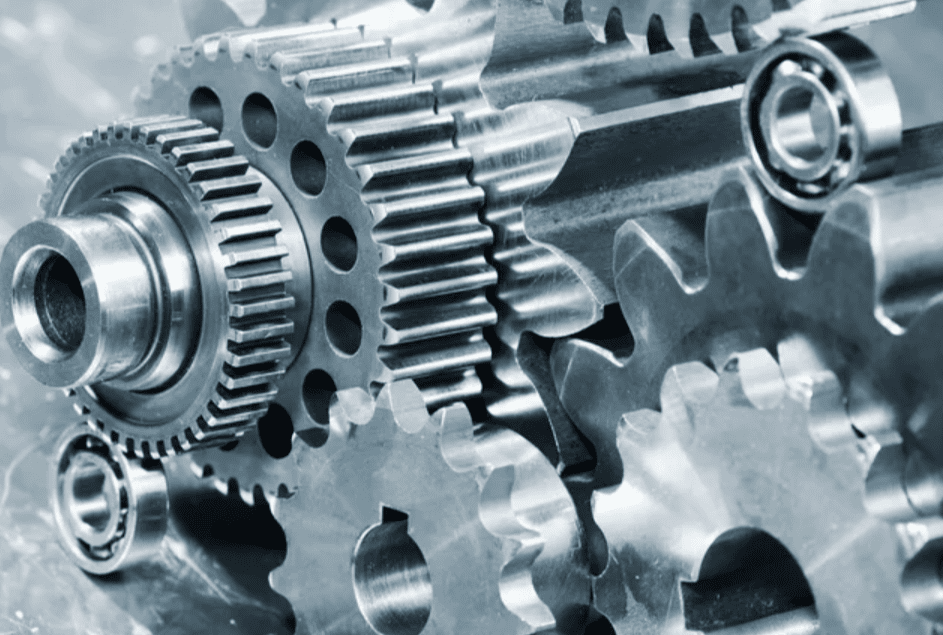 Close-up of metallic gears interlocked and functioning.